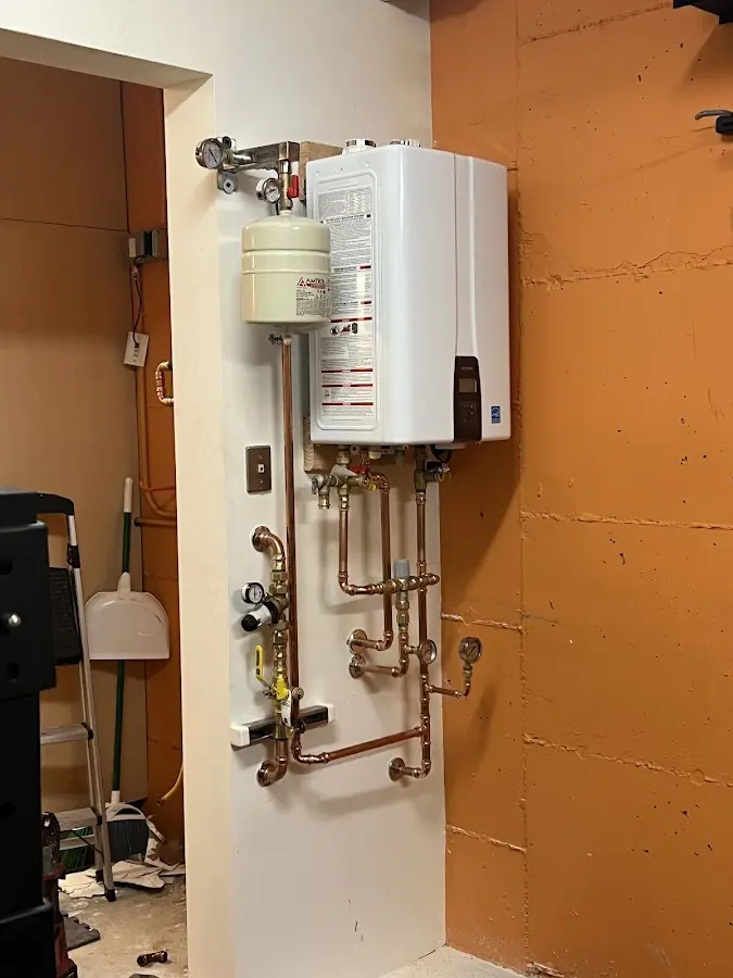 Plumbing technician inspecting water heater connections in Morris Plains